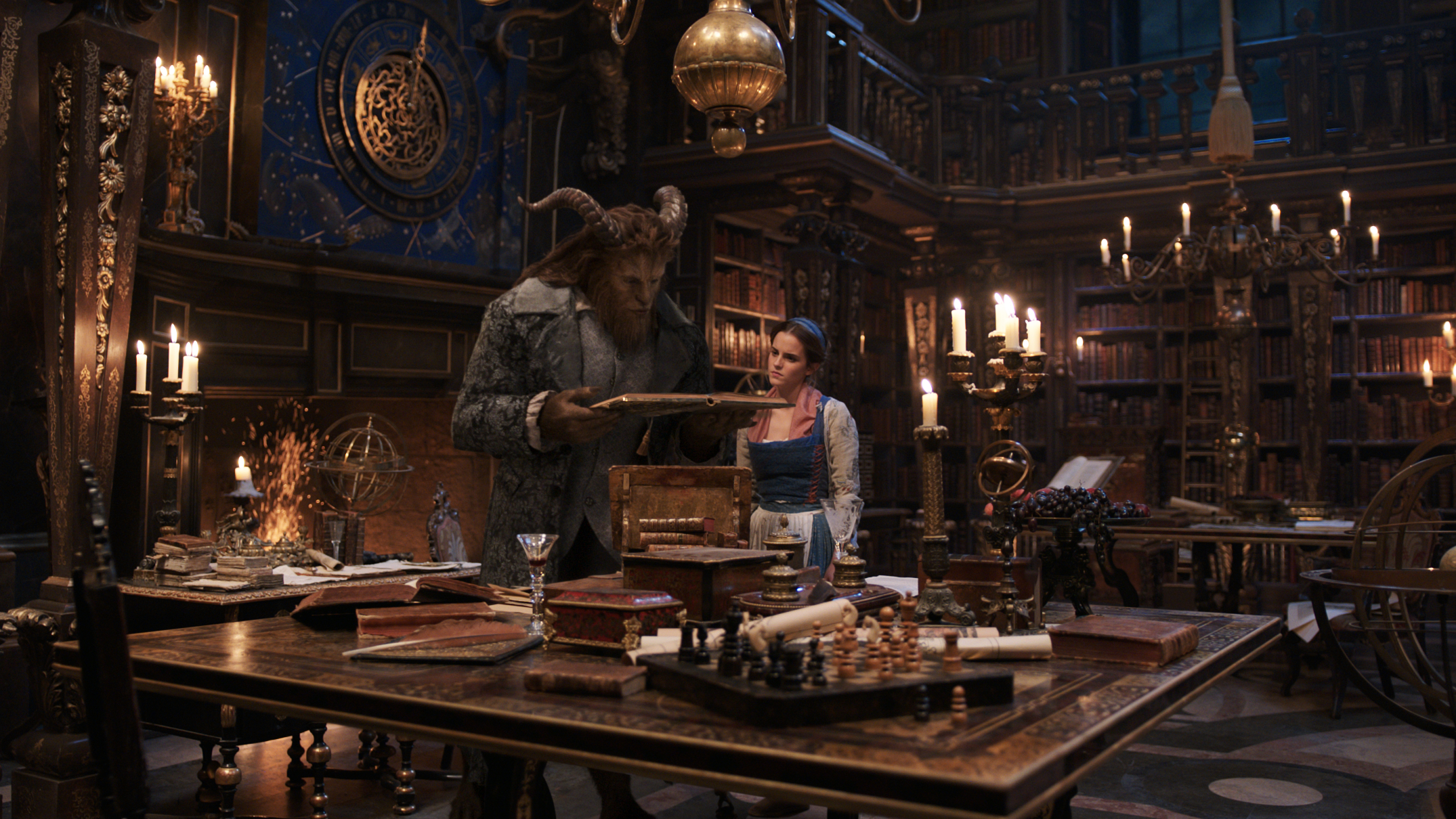 The Beast (Dan Stevens) and Belle (Emma Watson) in the castle library in Disney's BEAUTY AND THE BEAST. Original Image via Collider.com | onetakekate.com