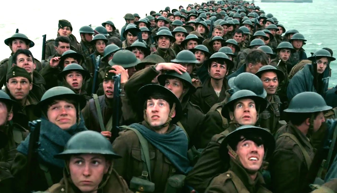 Troops wait on The Mole in Dunkirk. Image via JoBlo Movie Trailers | Dunkirk movie review | onetakekate.com
